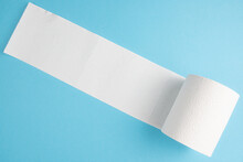 Partially Unrolled Toilet Paper Roll Isolated On Blue Background