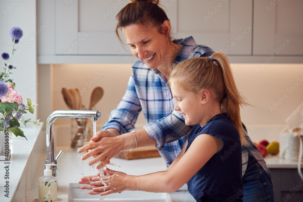 Mother And Daughter Washing Hands With Soap At Home To Stop Spread Of Infection In Health Pandemic - obrazy, fototapety, plakaty 