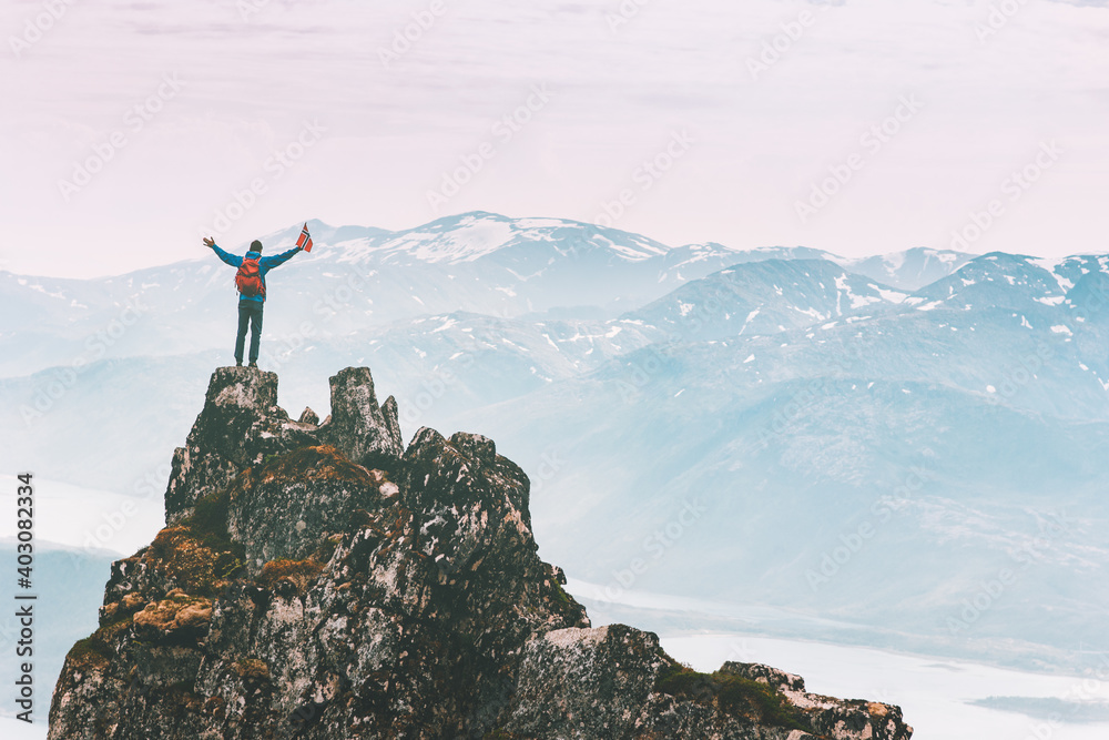 Man climbing on mountain top adventure travel outdoor extreme active lifestyle vacation tour hiking in Norway success raised hands Husfjellet peak - obrazy, fototapety, plakaty 