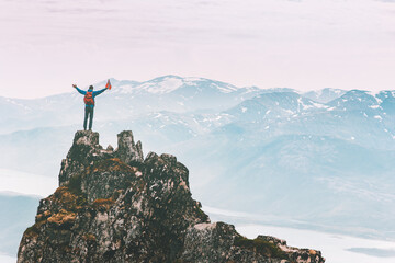 Wall Mural - Man climbing on mountain top adventure travel outdoor extreme active lifestyle vacation tour hiking in Norway success raised hands Husfjellet peak