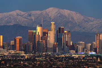 Wall Mural - Downtown Los Angeles skyline with snow capped mountains behind at twilight