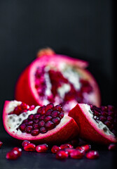 Wall Mural - pomegranate pieces on black background