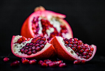 Wall Mural - pomegranate pieces on black background