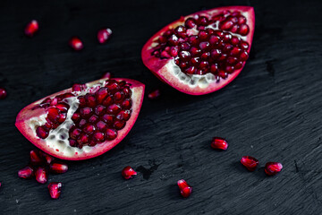 Wall Mural - pomegranate pieces on black background