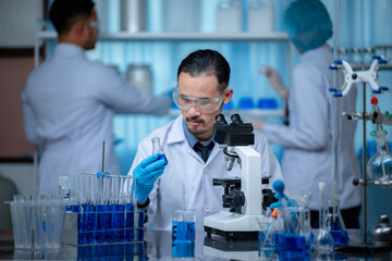 Wall Mural - group of laboratory assistants checking blood, using microscope and doing test for bacteria