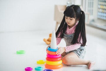 little children playing toys to education with family at home, girl happy and fun in childhood concept