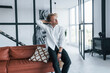 © standret - Beautiful interior. Caucasian young guy in elegant white shirt indoors at home