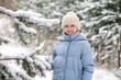 © Konstantin Koekin - Beautiful little girl playing with snow in winter forest. Walking and active rest in winter.