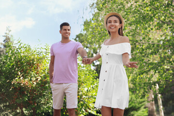 Wall Mural - Lovely couple walking together in park on sunny day