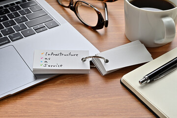 Poster - there's a laptop computer, a notebook, a pen and an open vocabulary book on the desk. the word infra