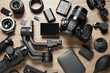 © New Africa - Flat lay composition with camera and video production equipment on wooden background