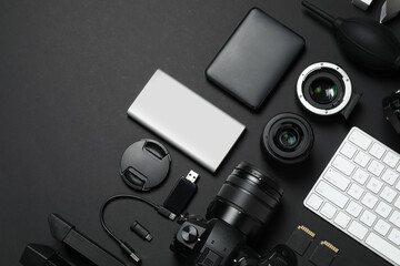 Wall Mural - camera, video production equipment and computer keyboard on black background, flat lay