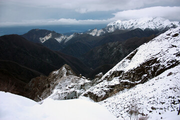 the mountains of the Apuan Alps covered with white snow in winter in Tuscany