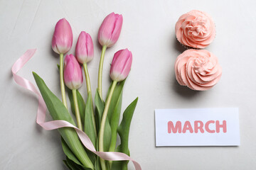 Wall Mural - 8 March greeting card design with tulips and cupcakes on light grey background, flat lay. International Women's day