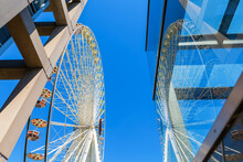 Ferris Wheel With Reflection In A Glass Construction