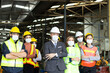 © Stella - Large group of confident industrial engineer worker and foreman boss with face mask wearing safety equipment standing with arms crossed at manufacturing plant factory
