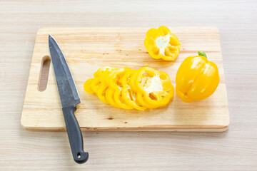 Sticker - bell pepper or sweet pepper and slices on wooden cutting board