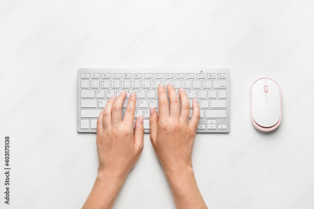 Female hands with computer keyboard on white background