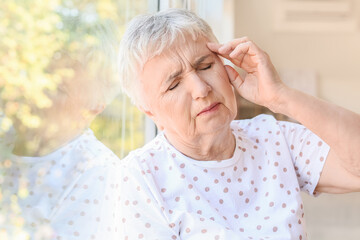 Sticker - Stressed senior woman suffering from headache at home