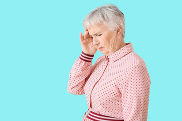 Sticker - Stressed senior woman suffering from headache on color background