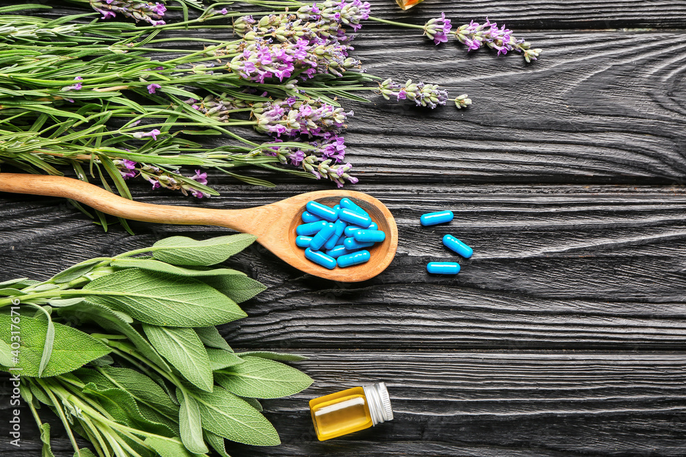 Spoon with plant based pills on wooden background