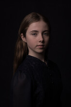 Classic Studio Portrait Of A Teenager Girl In Blue Dress In Painterly Rembrandt Style