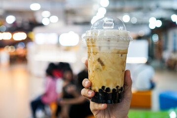 Wall Mural - Brown Sugar fresh milk bubble drink. A plastic cup of fresh milk with boba or bubble tapioca pearls. A famous Taiwanese drink.