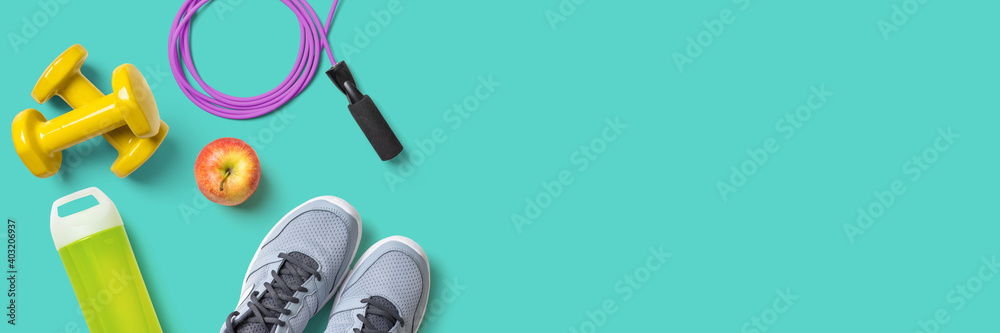 Fitness equipment on a turquoise background with copyspace - obrazy, fototapety, plakaty 