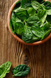Fresh spinach leaves on wooden background, top view