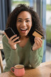 © LIGHTFIELD STUDIOS - excited african american woman holding smartphone and credit card
