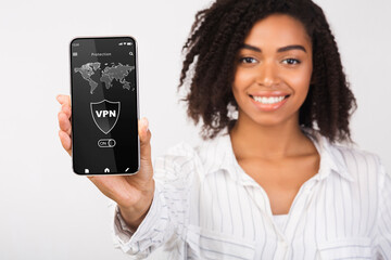 Poster - Black woman holding and showing smartphone with vpn app