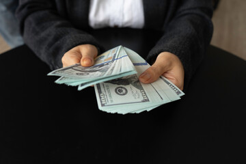 Closeup of businesswoman or Accountant finance with counting money Female hands with US dollar currency cash money