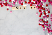 The Words I Love Ya Written In Scrabble Tiles On A Marble Kitchen Counter Top Surrounded By Valentines Candy