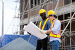 © NVB Stocker - Professional Construction and  Engineer team Working on workplace. Professional black architect and construction worker working look at blueprint plan on site.