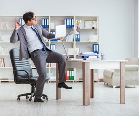 Businessman having fun taking a break in the office at work