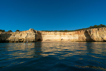 Sticker - father and twho young children paddle on a SUP board along the Algarve coast in Portugal