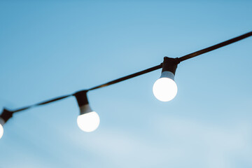 Light bulb decor on blue sky in the outdoor party.