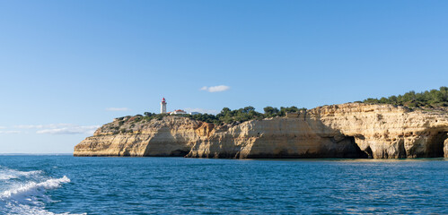 Wall Mural - view of the Alfanzina lighthouse on the beautiful Algarve coast of Portugal