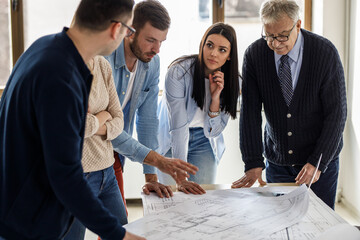 Wall Mural - College professor examining blueprint with group of his students.	
