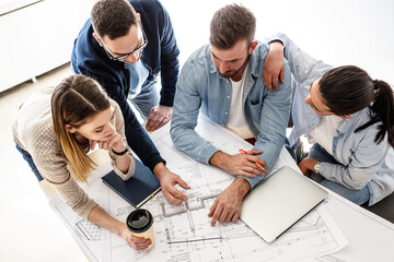 Wall Mural - Group of architecture students examining blueprint .Educational concept.	
