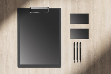 Poster - Wooden desktop with blank black clipboard
