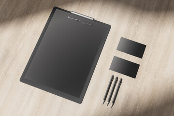 Poster - Top view of wooden desktop with blank clipboard,
