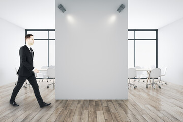 Aufkleber - Businessman walking in in conference room with blank white wall.