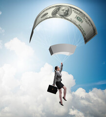 Businesswoman in golden parachute concept