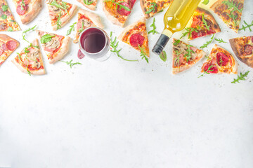 Wall Mural - Pizza party concept.  Set of pizzas with various fillings, Pieces of different pizza, glass and bottle with wine. Flatlay top view copy space on white background