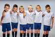 © Roman - children soccer team isolated in studio, friendly kids sport family leisure lifestyle concept. copy space advertisement