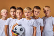 © Roman - soccer players after final game, confidently looking at camera. sports portrait of young football players. football youth junior team posing at camera