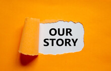 Our Story Symbol. Words 'Our Story' Appearing Behind Torn Orange Paper. Business And Our Story Concept. Copy Space.