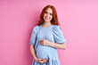 © Roman - pregnant woman posing at camera isolated on pink background, young female enjoy pregnancy, expecting baby