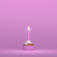 A Birthday Candle Lighting On A Creamy Muffin Cupcake On A Pink Background And Colors And Space For Text